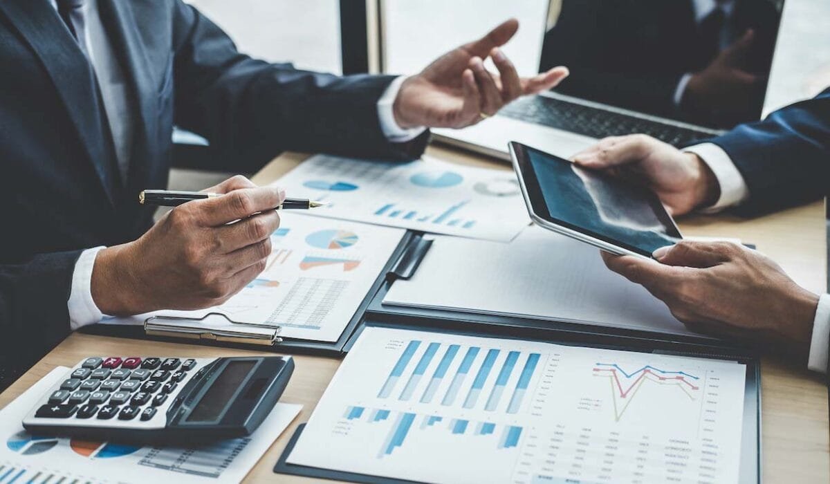 Finance manager meeting discussing company growth project success financial statistics, professional investor working start up project for strategy plan with document, laptop and digital tablet.